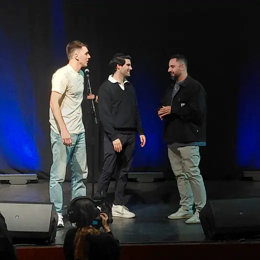 Dovi Neuburger on stage with local comics