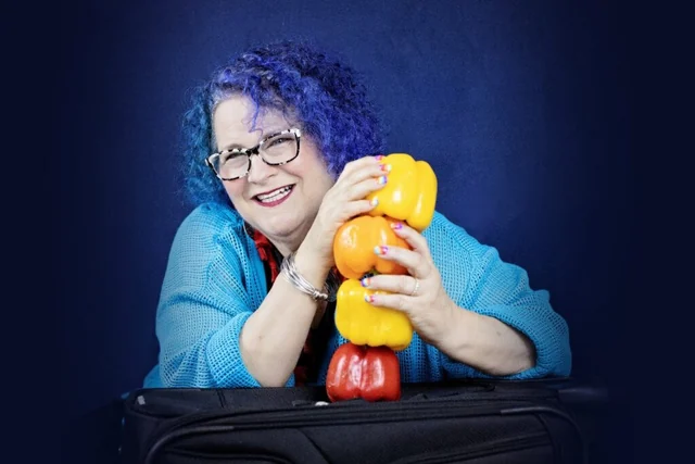 Hani Skutch smiling with colorful peppers