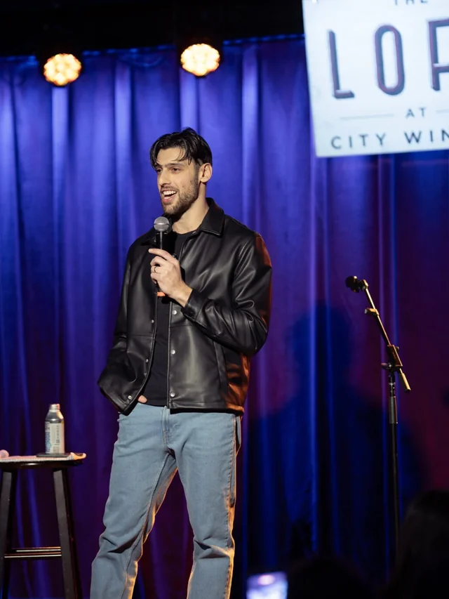 Mikey Greenblatt performing stand-up comedy on stage